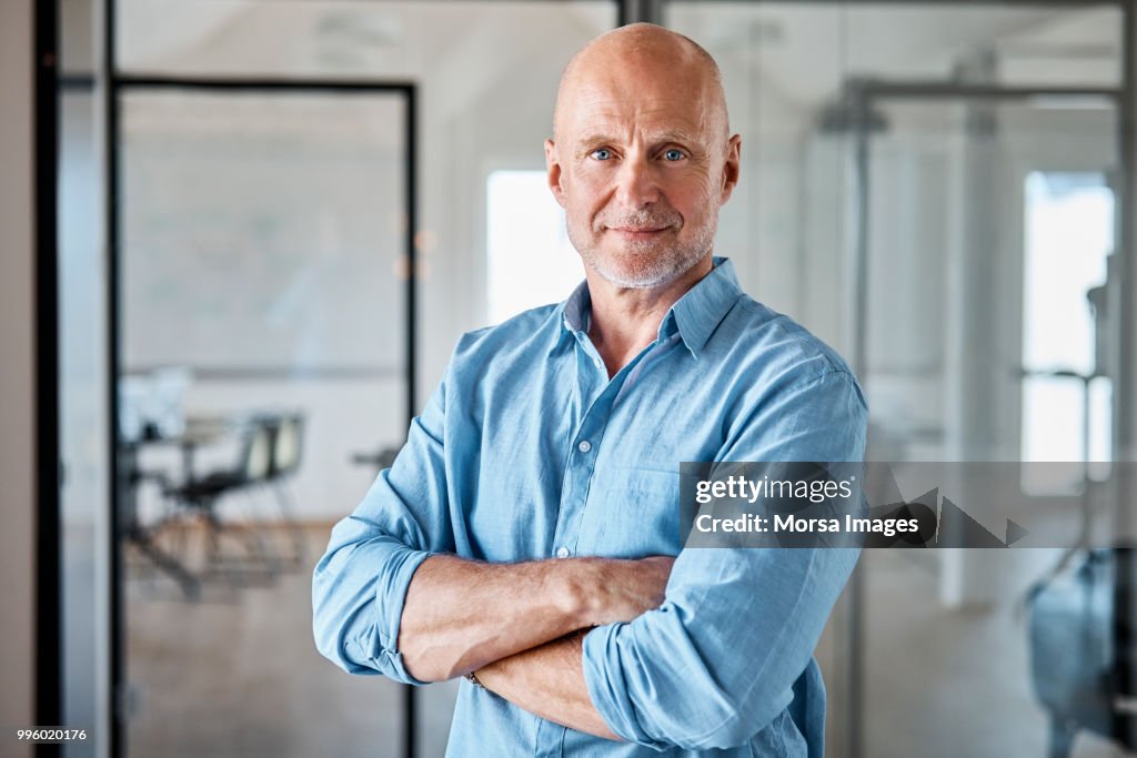 Portrait of confident executive with arms crossed