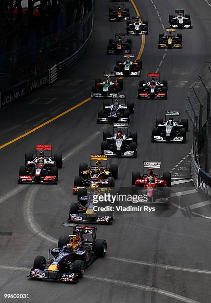 Mark Webber of Australia and Red Bull Racing leads the field into the first corner at the start of the Monaco Formula One Grand Prix at the Monte...