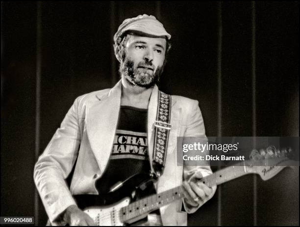 Michael Chapman performs on stage at Hammersmith Odeon, London, 1976.