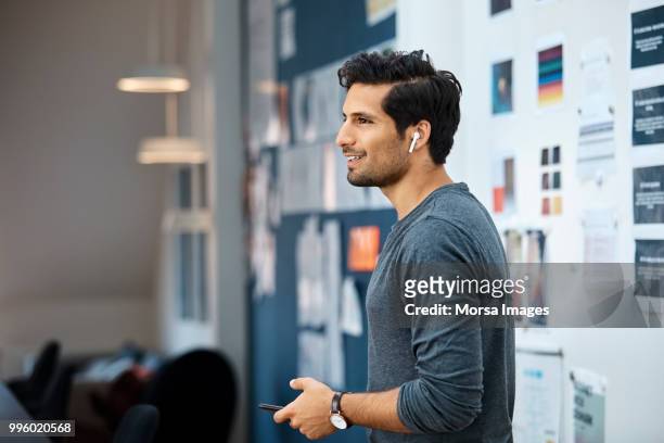 businessman using wireless headset at office - man standing and gesturing stock pictures, royalty-free photos & images