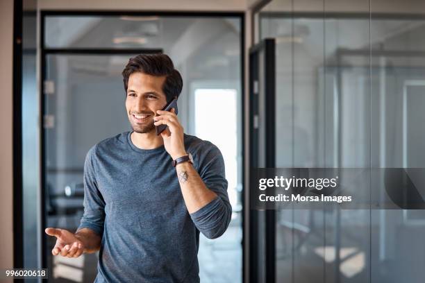 entrepreneur talking on mobile phone at office - man talking phone stock pictures, royalty-free photos & images