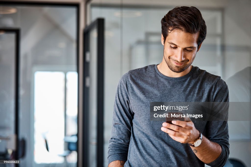 Professional using mobile phone at office