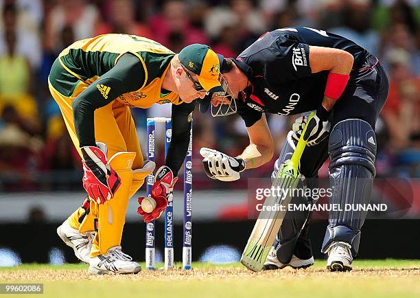 Australian wicketkeeper Brad Haddin and English batsman Kevin Pietersen bend to pick up the ball during the Men's ICC World Twenty20 final match...