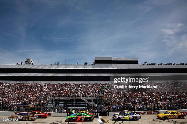 Martin Truex Jr., driver of the NAPA Auto Parts Toyota, and Kasey Kahne, driver of the Budweiser Ford, lead the field to the green flag to start the...