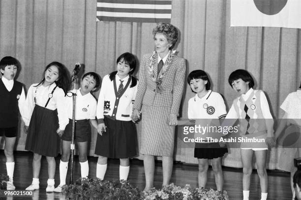 Nancy Reagan, wife of U.S. President Ronald Reagan sings songs with children during her visit to an elementary school at a spouse programme on the...