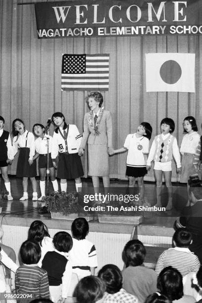 Nancy Reagan, wife of U.S. President Ronald Reagan sings songs with children during her visit to an elementary school at a spouse programme on the...
