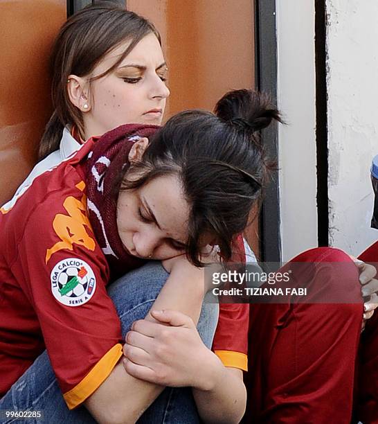 Roma supporters react at the Roma supporters' club Testaccio in Rome after their team's last season match against Chievo on May 16, 2010. Inter Milan...