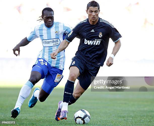 Cristiano Ronaldo of Real Madrid fights with Felipe Caicedo of Malaga during the La Liga match between Malaga and Real Madrid at La Rosaleda Stadium...