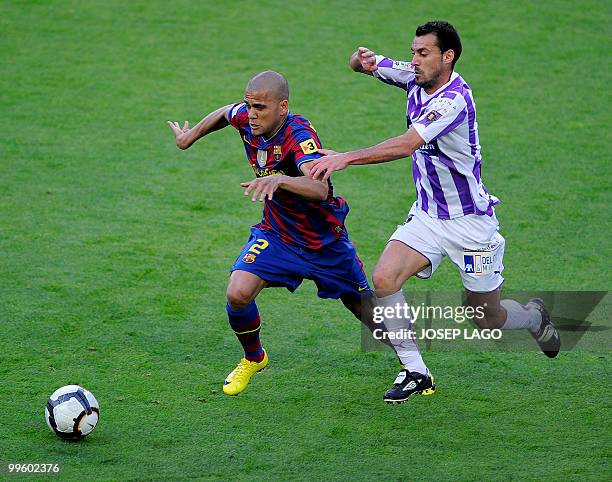 Barcelona's Brazilian defender Daniel Alves fights for the ball with Valladolid's defender Javi Baraja during their Spanish League football match at...