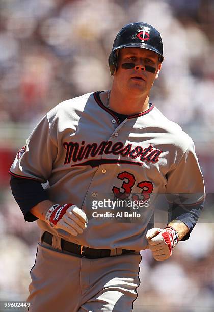 Justin Morneau of the Minnesota Twins rounds the bases after hitting a home run in the second inning against The New York Yankees during their game...