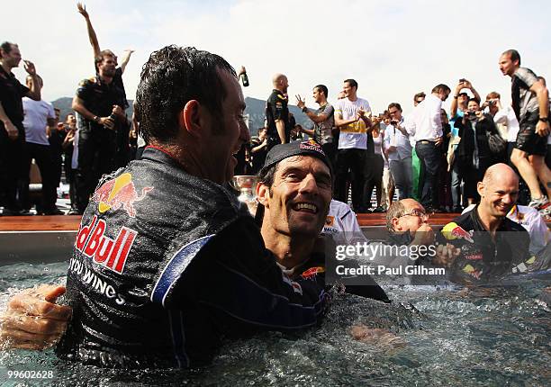 Mark Webber of Australia and Red Bull Racing celebrates with Red Bull Racing Chief Mechanic Kenny Handkammer in the Red Bull Energy Station swimming...