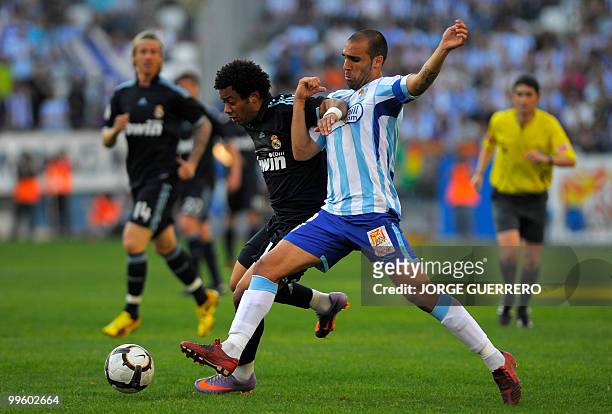 Real Madrid's Brazilian defender Marcelo vies for the ball with Malaga's Jesus Gamez during a Spanish league football match at Rosaleda stadium in...