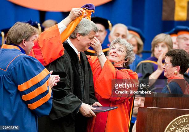James "Jamie" Dimon, chairman and chief executive officer of JPMorgan Chase & Co., center, is presented with a sash as he receives an honorary Doctor...