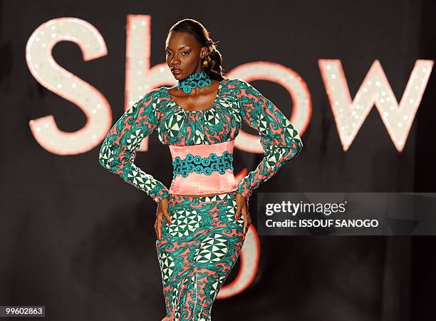 Model sports a creation on the catwalk during the closing of the 5th edition of "Afrik Fashion" in Abidjan on May 15, 2010. Designers from Benin,...