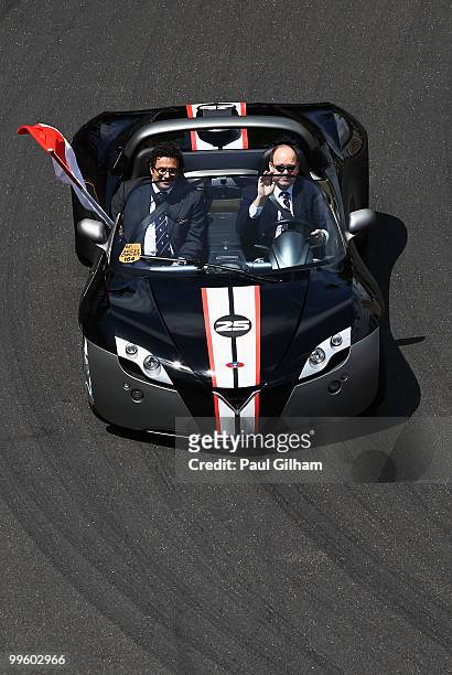 Prince Albert II of Monaco greets the crowd as he is driven round the track before the start of the Monaco Formula One Grand Prix at the Monte Carlo...