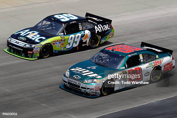 Carl Edwards, driver of the Aflac Ford, and Dale Earnhardt Jr., driver of the AMP Energy/National Guard Chevrolet, race side by side during the...