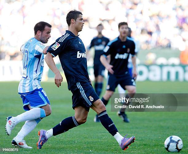 Cristiano Ronaldo of Real Madrid gives a pass during the La Liga match between Malaga and Real Madrid at La Rosaleda Stadium on May 16, 2010 in...