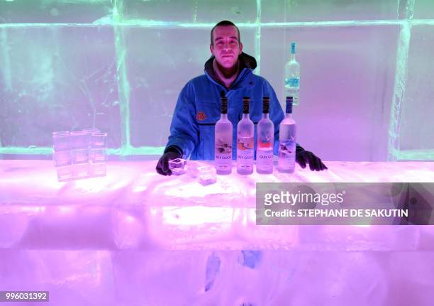 Barman is pictured 12 December 2005 inside the first ice bar in Paris, created by Parisian artist Laurent Saksik. Work on more than 20 tons of ice...