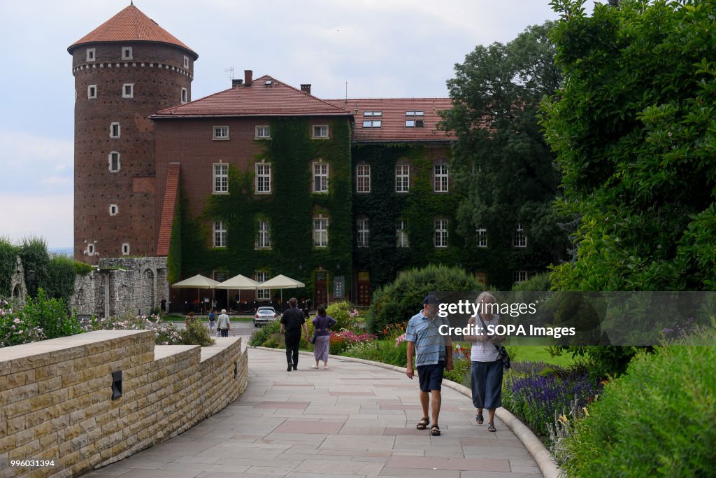 Tourists walk at the Italian-styled main courtyard of Wawel...