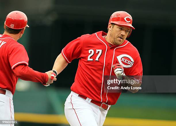 Scott Rolen of the Cincinnati Reds is congratulated by third base coach Mark Berry after hitting a home run during the game against the St. Louis...