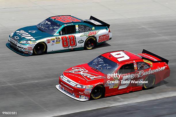 Dale Earnhardt Jr., driver of the AMP Energy/National Guard Chevrolet, and Kasey Kahne, driver of the Budweiser Ford, race side by side during the...