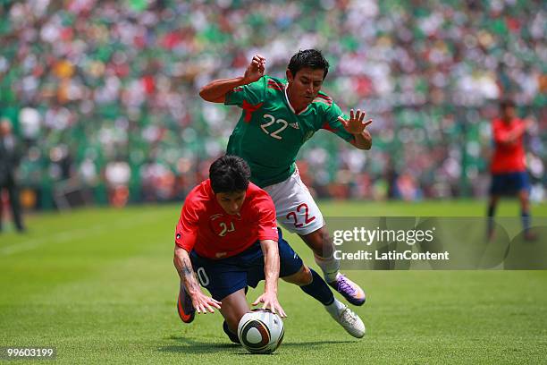 Alberto Medina of Mexico fights for the ball with Jaime Valdes of Chile during a friendly match as part of the Mexico National team preparation for...