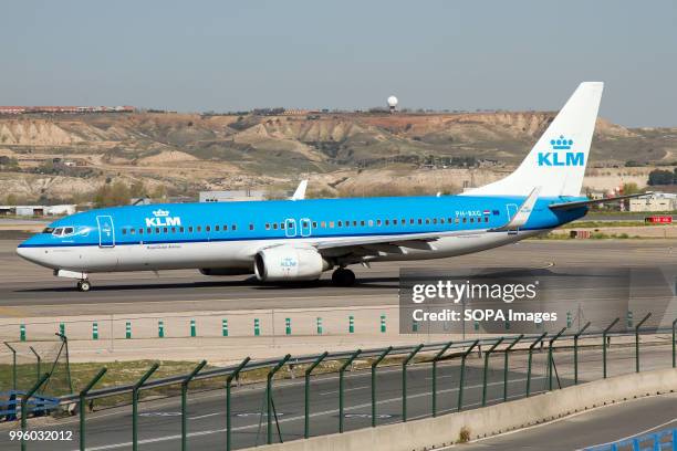 Royal Dutch Airlines Boeing 737-800 on the taxiway at Madrid Barajas airport.