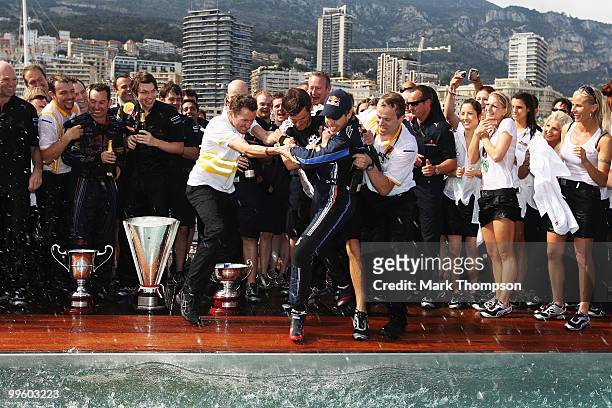 Sebastian Vettel of Germany and Red Bull Racing is thrown into the Red Bull Energy Station swimming pool following the Monaco Formula One Grand Prix...