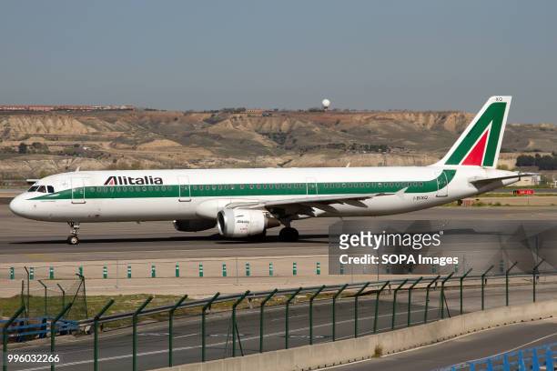 An Alitalia Airbus A321 on the taxiway at Madrid Barajas airport.