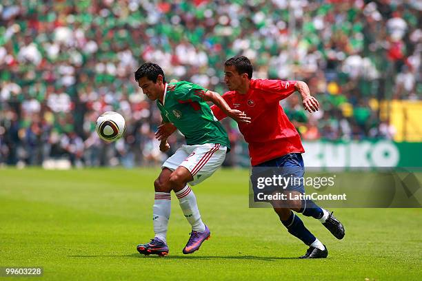 Alberto Medina of Mexico fights for the ball with Roberto Cereceda of Chile during a friendly match as part of the Mexico National team preparation...