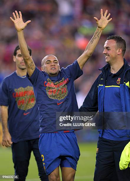 Barcelona's Brazilian defender Dani Alves celebrates with teamamtes after winning their Spanish League football match against Valladolid at Camp Nou...