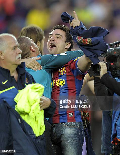 Barcelona's midfielder Xavi Hernandez celebrates with teammates after winning their Spanish League football match against Valladolid at Camp Nou...