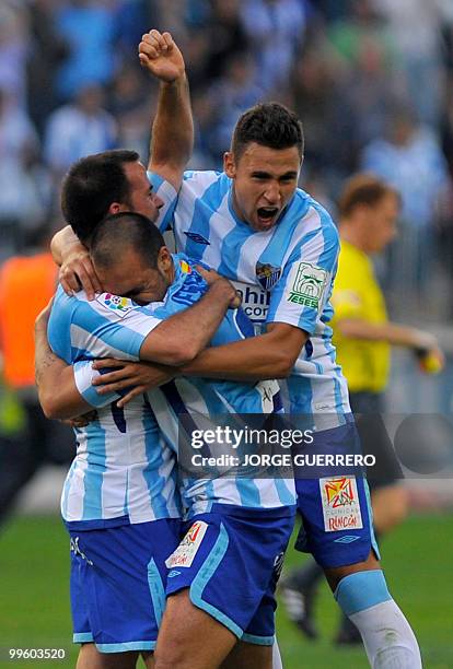 Malaga's midfielder Antonio Galdeano , Malaga's Jesus Gamez and Ivan Gonzalez celebrates their victory against Real Madrid during a Spanish league...