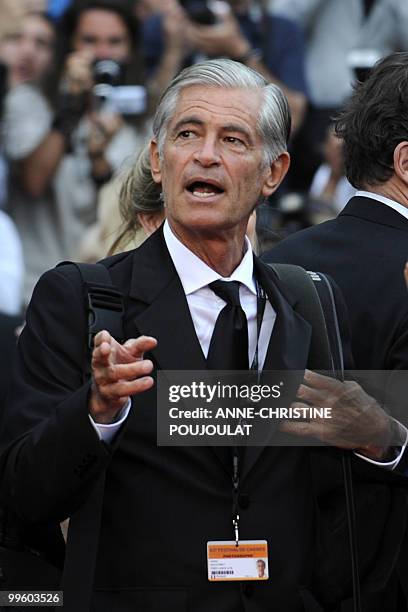 Photographer James Nachtwey gestures as people arrive for the screening of "La Princesse de Montpensier" presented in competition at the 63rd Cannes...