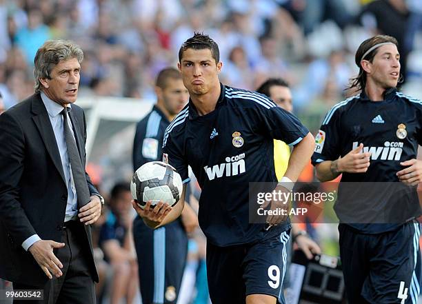 Real Madrid's Portuguese forward Cristiano Ronaldo reacts with coach Manuel Pellegrini during a football match against Malaga at La Rosaleda's...