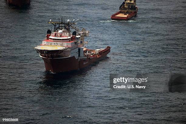 In this handout from the U.S. Navy, a ship actively participating in cleanup efforts patrols in the vicinity of the source of the oil spill May 13,...