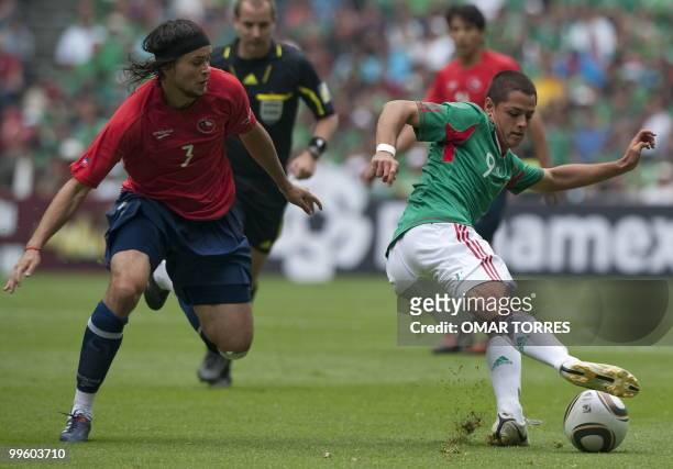 Javier Hernandez of Mexico vies for the ball with Jose Fuenzalida of Chile during their friendly footbal match before their departure for South...