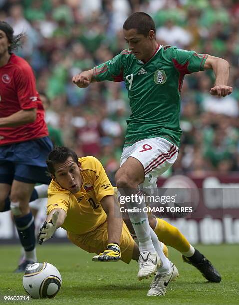 Javier Hernandez of Mexico vies for the ball with goalkeeper Luis Marin of Chile during their friendly footbal match before their departure for South...