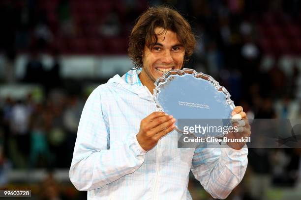 Rafael Nadal of Spain bites his winners trophy after his straight sets victory against Roger Federer of Switzerland in the mens final match during...