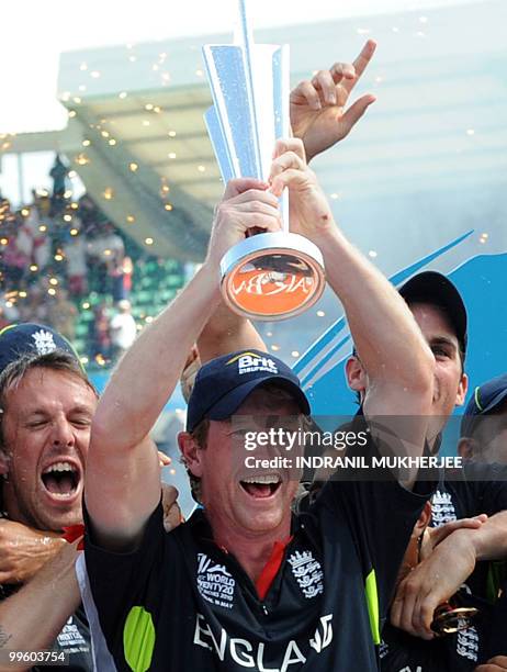 England cricketers celebrate with the trophy after winning the Men's ICC World Twenty20 final match between Australia and England at the Kensington...