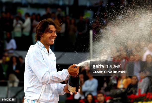 Rafael Nadal of Spain sprays champagne after his straight sets victory against Roger Federer of Switzerland in the mens final match during the Mutua...