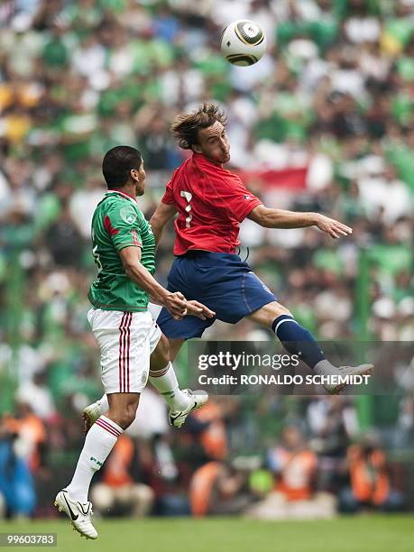 Javier Hernandez of Mexico vies the ball with Jose Pedro Fuenzalida of Chile, during a friendly football game, at the Azteca Stadium in Mexico City...