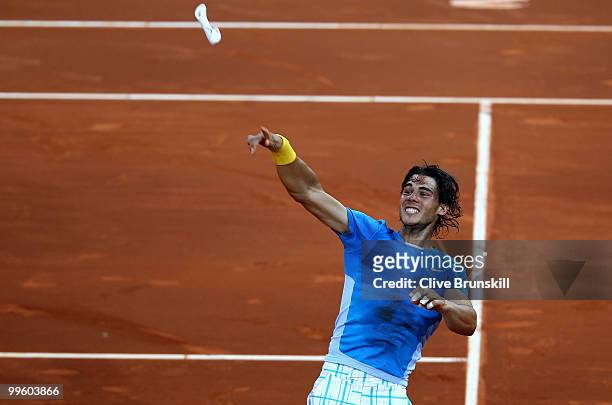 Rafael Nadal of Spain celebrates by throwing his wrist sweat band to the crowd after his straight sets victory against Roger Federer of Switzerland...