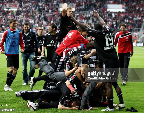 Players of Nuernberg celebrate after the Bundesliga play off leg two match between FC Augsburg and 1. FC Nuernberg at the Impuls Arena on May 16,...