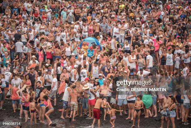 Revellers attend the Virgin del Carmen festivity, honouring the patron saint of fishermen, at the Puerto de la Cruz on the Spanish Canary island of...