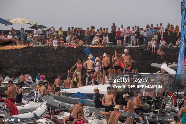 Revellers attend the Virgin del Carmen festivity, honouring the patron saint of fishermen, at the Puerto de la Cruz on the Spanish Canary island of...