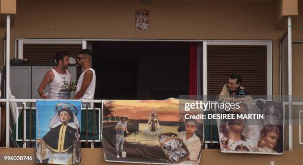 Revellers attend the Virgin del Carmen festivity, honouring the patron saint of fishermen, at the Puerto de la Cruz on the Spanish Canary island of...