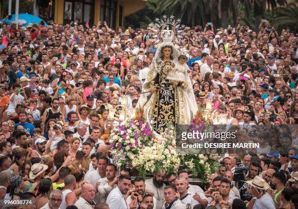 Carriers of the Great God Power brotherhood carry the Virgin del Carmen statue at the Puerto de la Cruz on the Spanish Canary island of Tenerife on...