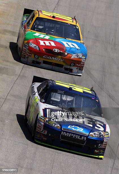 Jimmie Johnson, driver of the Lowe's Chevrolet, leads Kyle Busch, driver of the M&M's Toyota, during the NASCAR Sprint Cup Series Autism Speaks 400...