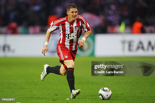 Bastian Schweinsteiger of Bayern runs with the ball during the DFB Cup final match between SV Werder Bremen and FC Bayern Muenchen at Olympic Stadium...